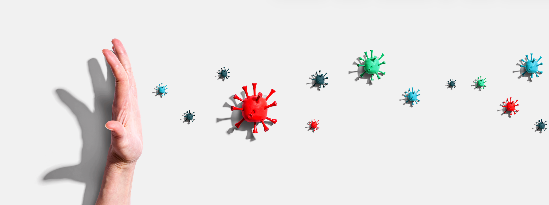 a hand with animated germs coming off from the hand