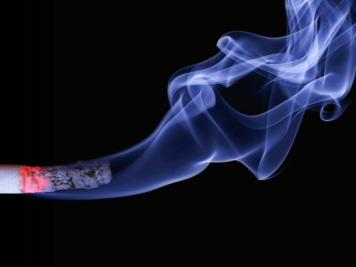 Do Air Purifiers Help with Smoke Smell Removal? Image courtesy Pexels: https://www.pexels.com/photo/close-up-photo-of-lighted-cigarette-stick-70088/