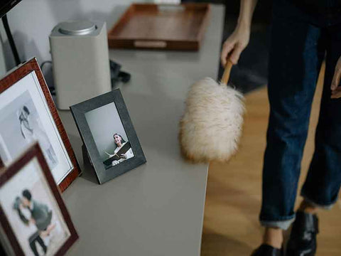 Do Air Purifiers Really Help With Dust? What You Need To Know. Image courtesy Pexels: https://www.pexels.com/photo/close-up-of-cleaning-the-shelves-with-pictures-6943507/