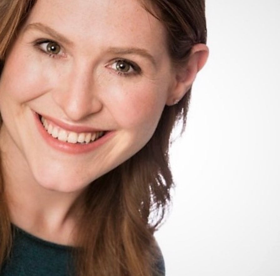 Close-up of a woman with a neutral expression on a white background