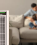 Air purifier with a blurred background of a family on a couch