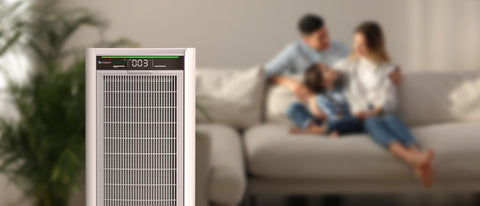 Air purifier with a blurred background of a family on a couch